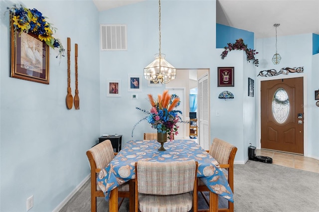 dining room featuring carpet, lofted ceiling, and a chandelier