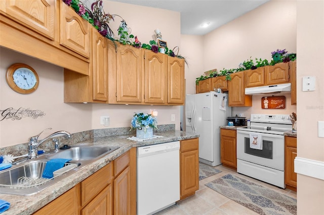 kitchen featuring white appliances, sink, and light tile patterned floors