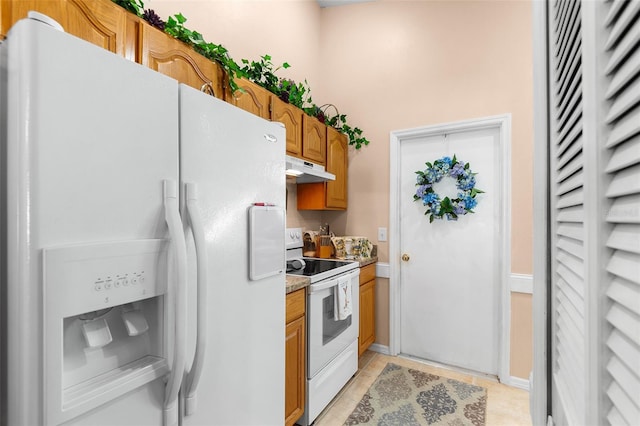 kitchen with light tile patterned floors and white appliances