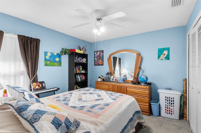 carpeted bedroom with a closet and ceiling fan