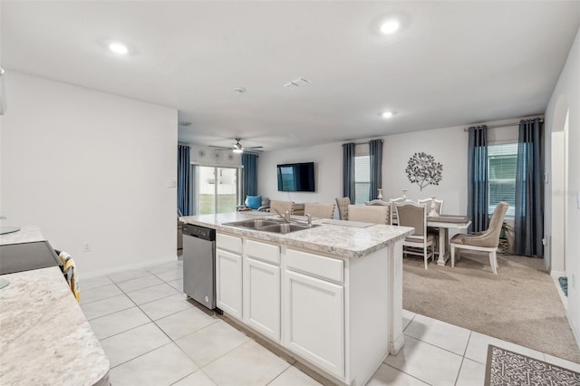 kitchen with sink, white cabinets, dishwasher, a center island with sink, and light colored carpet