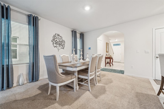 dining space featuring light colored carpet