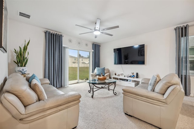 living room with ceiling fan and light colored carpet