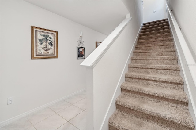 staircase featuring tile patterned flooring