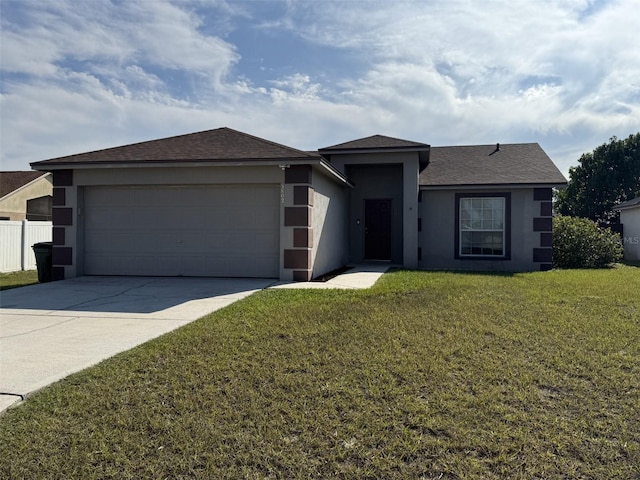 view of front of home with a garage and a front lawn