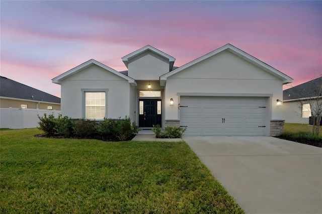 view of front of house with a lawn and a garage