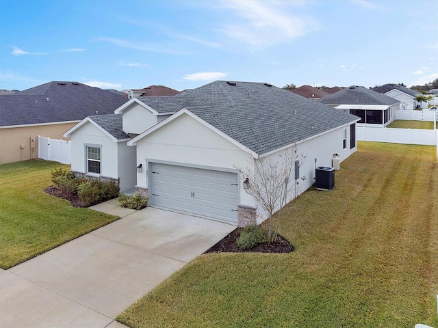 view of front of property with cooling unit, a front lawn, and a garage