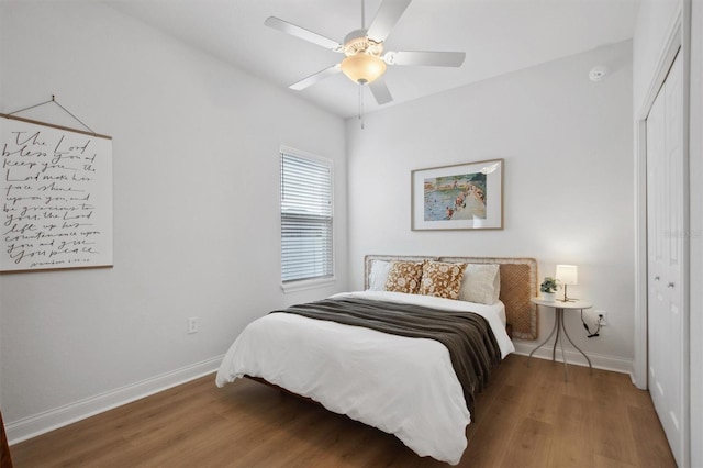 bedroom with hardwood / wood-style flooring, ceiling fan, and a closet