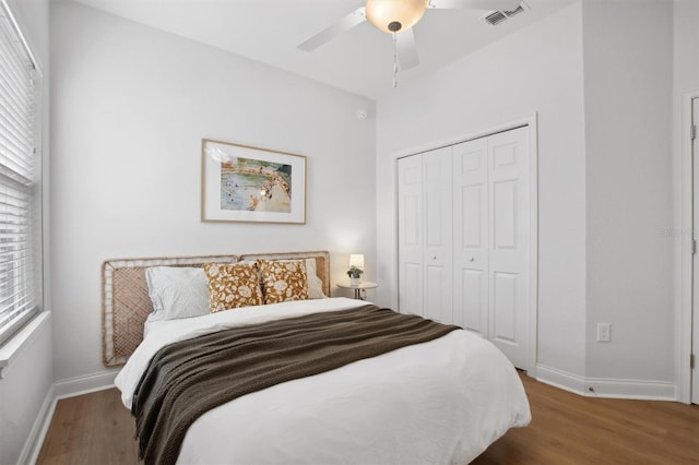 bedroom featuring dark hardwood / wood-style flooring, a closet, and ceiling fan