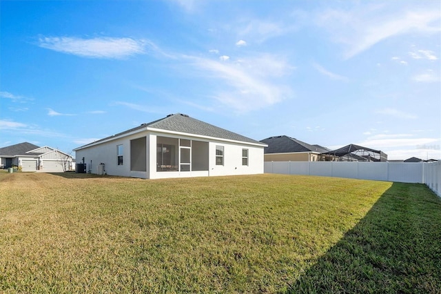 back of house with a lawn