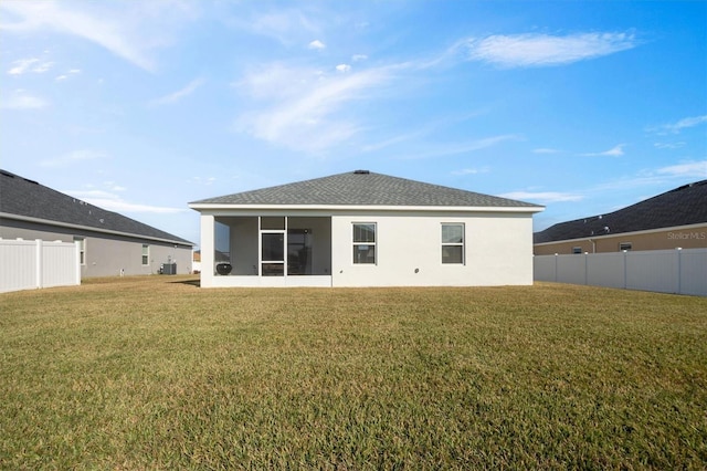 back of property featuring a yard and a sunroom