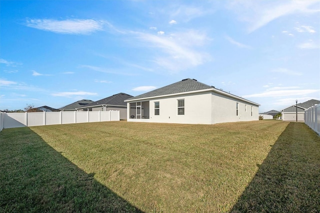 rear view of property with a lawn