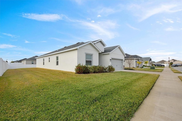 view of side of home with a lawn and a garage