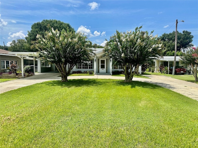 obstructed view of property featuring a front lawn