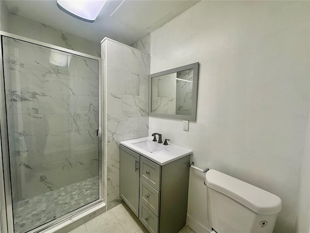 bathroom featuring vanity, toilet, and a shower with shower door