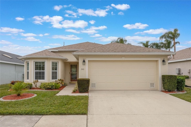 view of front of home featuring a front yard and a garage