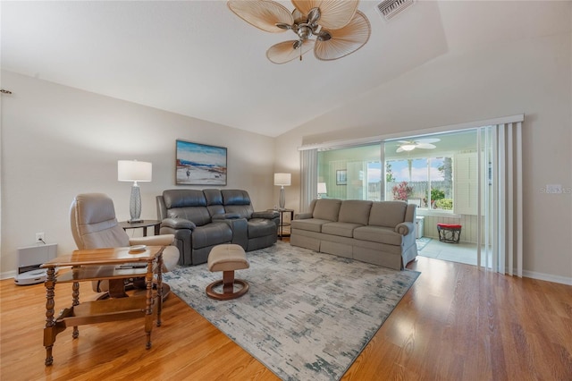 living room featuring hardwood / wood-style flooring and vaulted ceiling