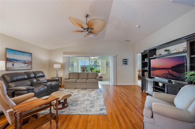 living room with ceiling fan, light hardwood / wood-style flooring, and vaulted ceiling