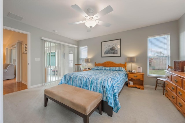 bedroom featuring access to exterior, light carpet, and ceiling fan