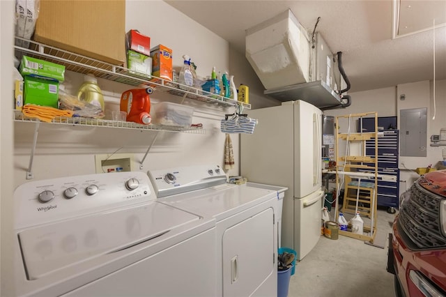 washroom with washing machine and clothes dryer and electric panel