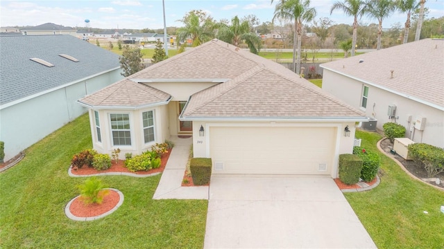 view of front of house featuring a front yard, a garage, and central AC unit