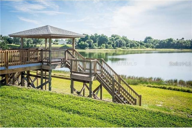 dock area featuring a gazebo, a yard, and a water view