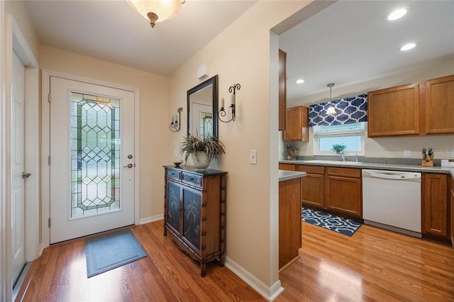 foyer with light hardwood / wood-style floors and sink