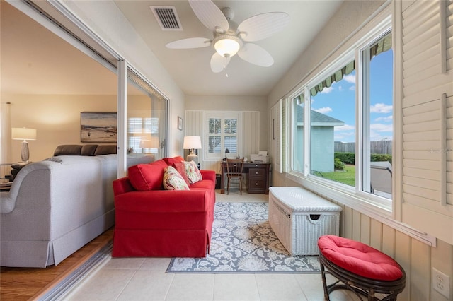 sunroom featuring ceiling fan