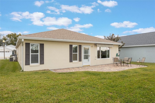 rear view of house with a lawn, a patio area, and central air condition unit