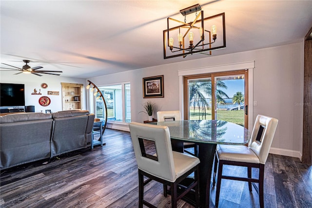 dining room featuring ceiling fan with notable chandelier and dark hardwood / wood-style flooring