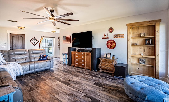 living room featuring ceiling fan and dark wood-type flooring