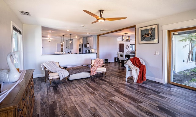 living room featuring dark hardwood / wood-style flooring and ceiling fan