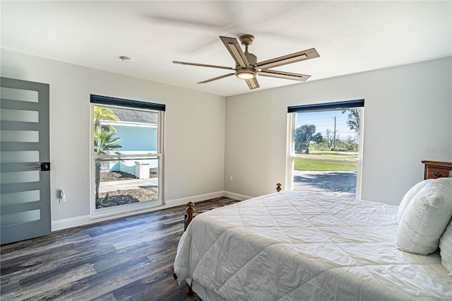 bedroom featuring dark wood-type flooring, ceiling fan, and multiple windows