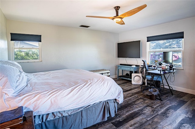 bedroom with ceiling fan and dark hardwood / wood-style flooring