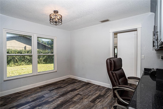 unfurnished office featuring dark hardwood / wood-style flooring and a textured ceiling