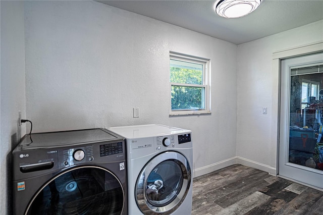 laundry area featuring washing machine and dryer and dark hardwood / wood-style floors