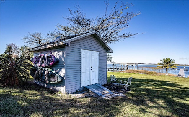 view of outdoor structure featuring a yard and a water view