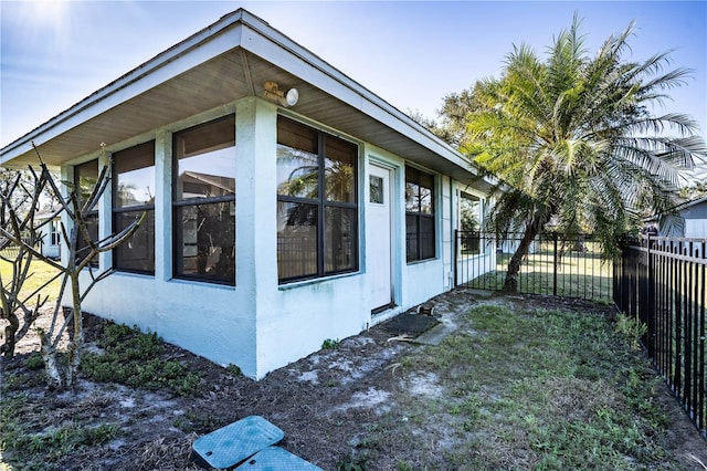 view of side of property with a lawn