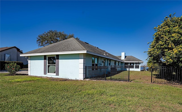 back of property featuring a lawn