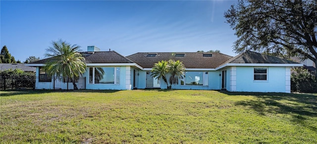 rear view of house featuring a yard