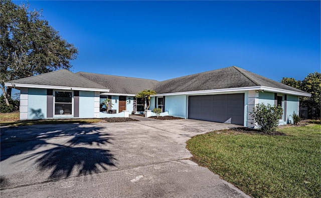 single story home featuring a front lawn and a garage