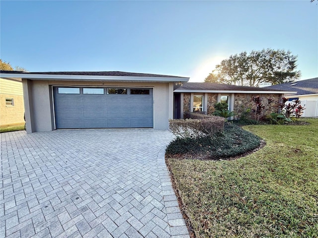 view of front of property with a garage and a front yard