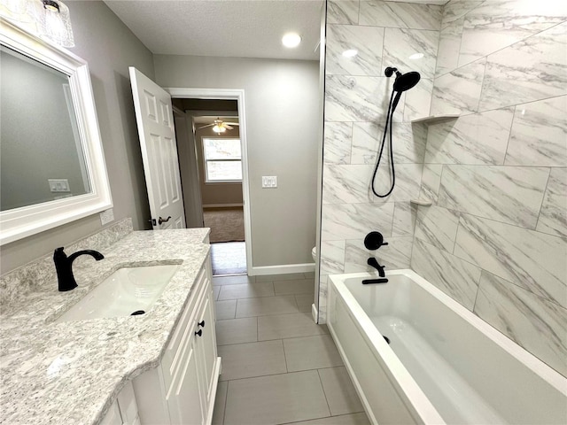 full bathroom featuring tile patterned flooring, tiled shower / bath combo, vanity, a textured ceiling, and toilet