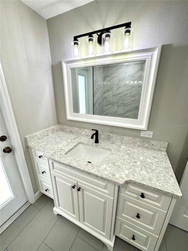 bathroom featuring tile patterned flooring and vanity