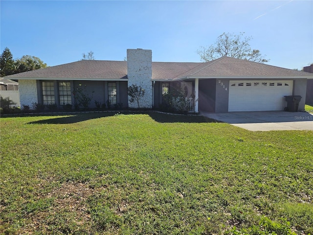 single story home with a garage and a front lawn