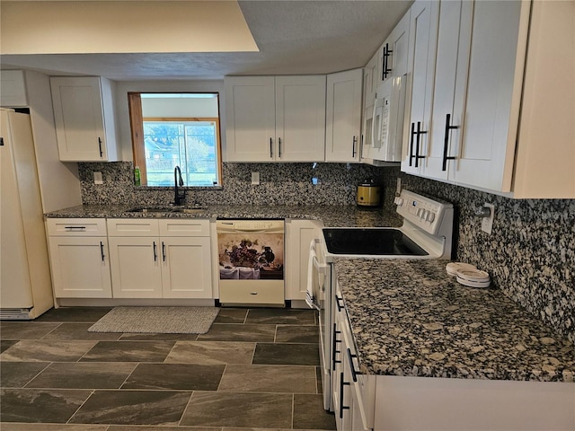 kitchen featuring white appliances, backsplash, white cabinets, sink, and dark stone countertops