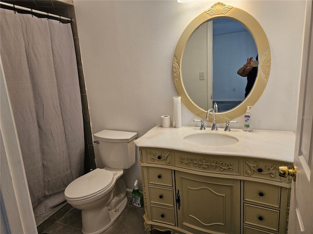 bathroom featuring tile patterned floors, vanity, toilet, and walk in shower