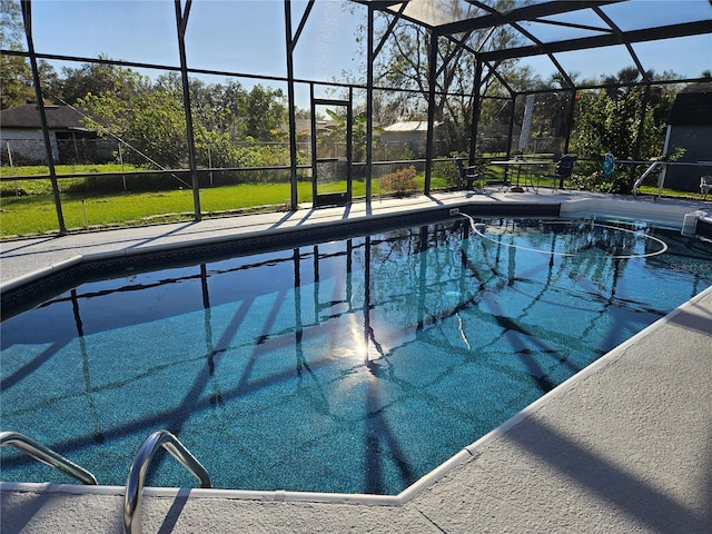 view of pool with a lanai and a yard