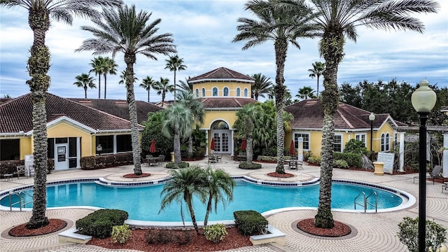 view of swimming pool featuring french doors and a patio area