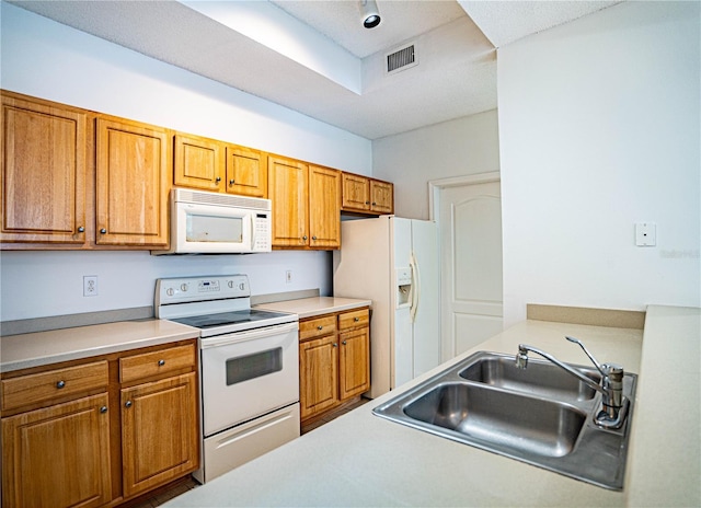 kitchen featuring sink and white appliances